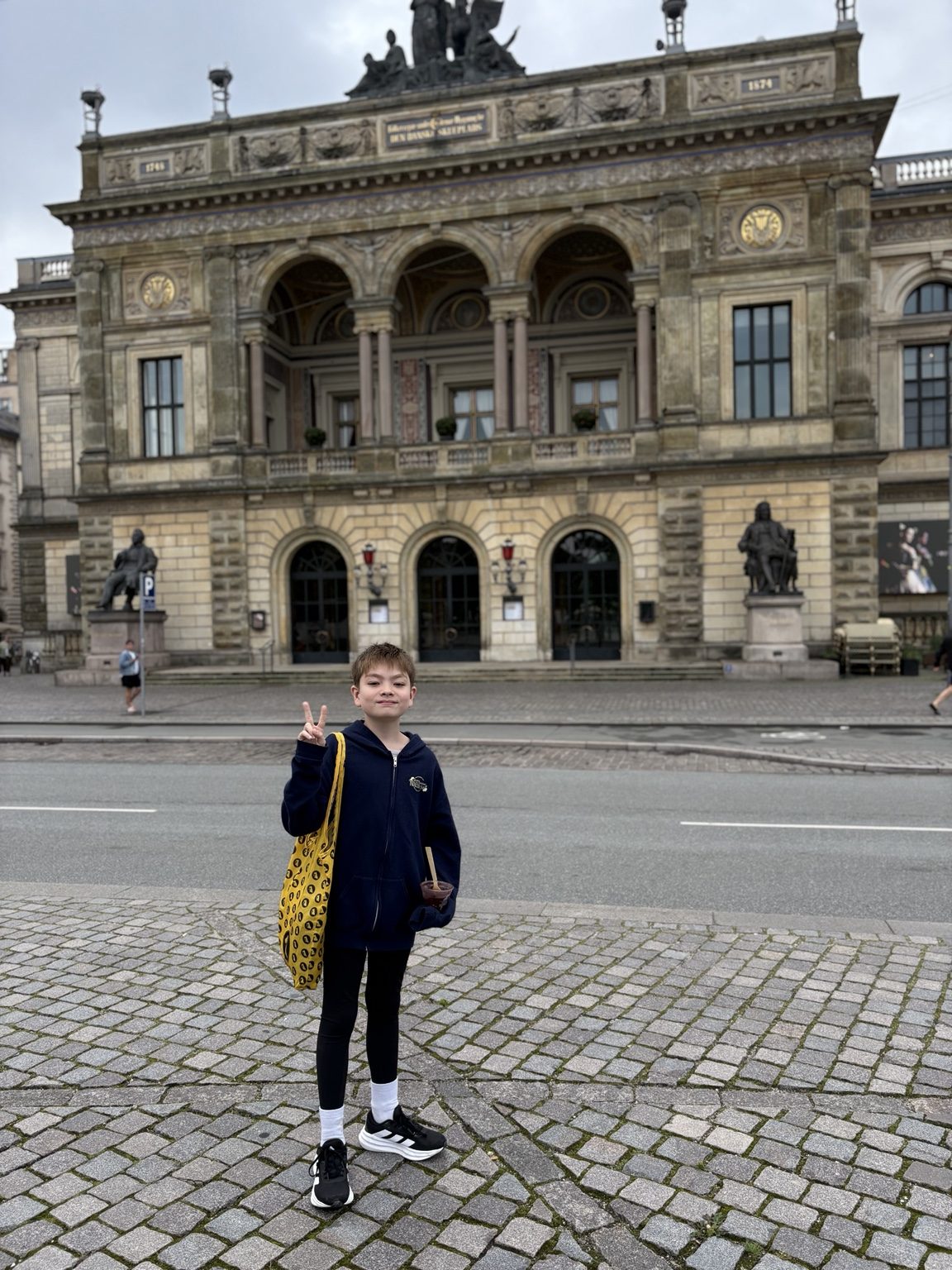 Young dancer outside a historic European performing arts building