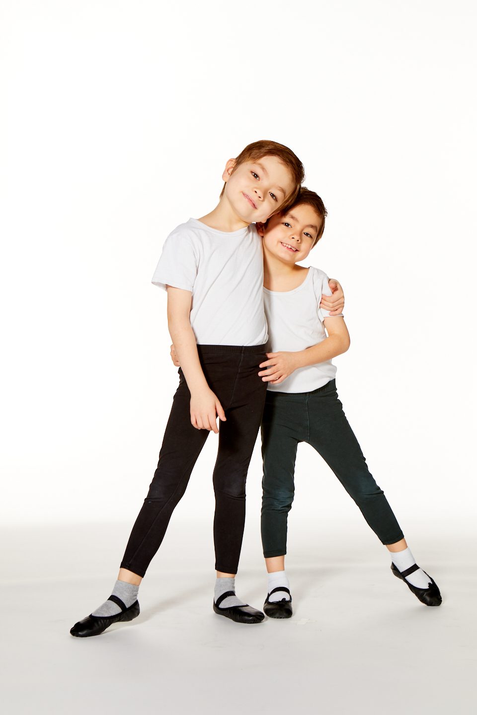 Two young dancers together in ballet clothes